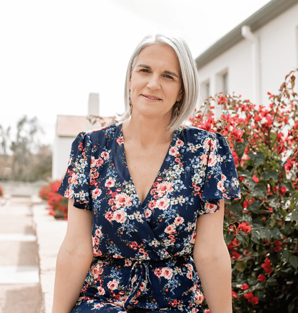 Energy healer Phoenix seated in a garden with flowers, offering gentle energy healing in Phoenix AZ